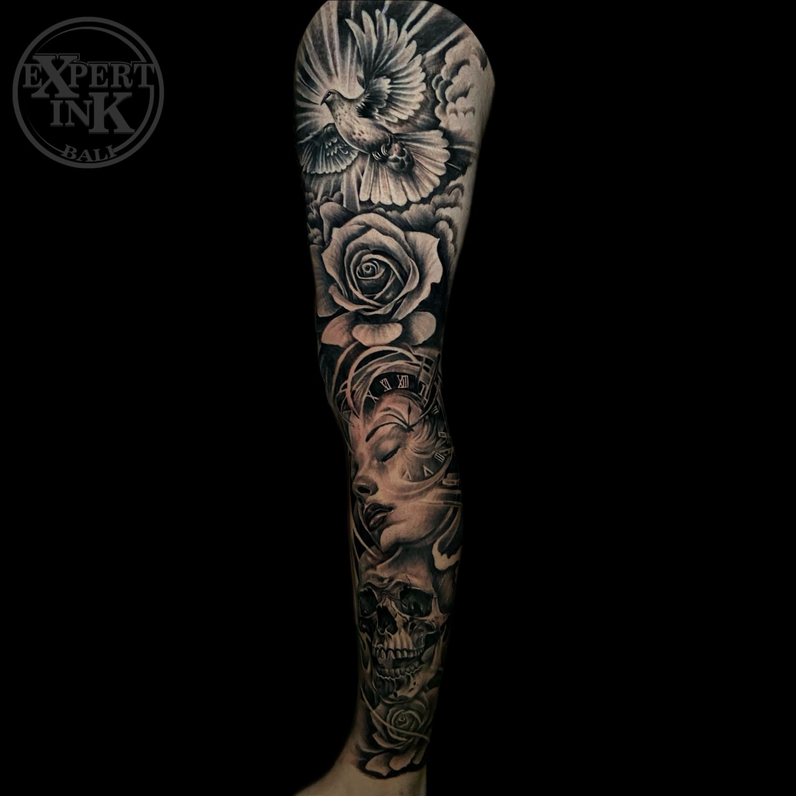 Realistic black and grey sleeve tattoo featuring roses and mandala patterns