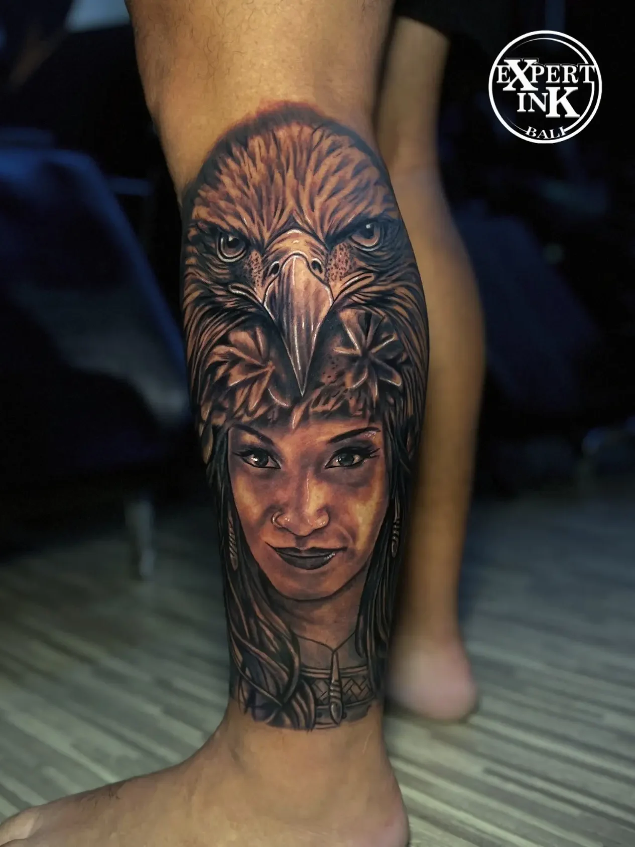 Black and grey portrait tattoo of a public figure on the leg