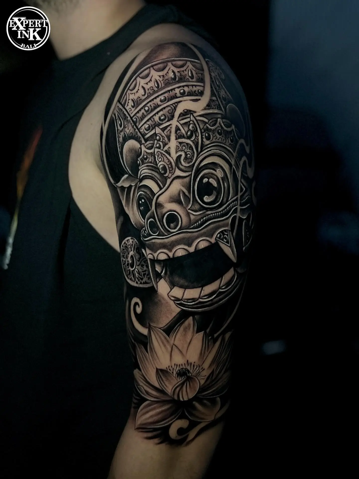 Close-up of a Balinese-style tattoo with intricate mythological line work