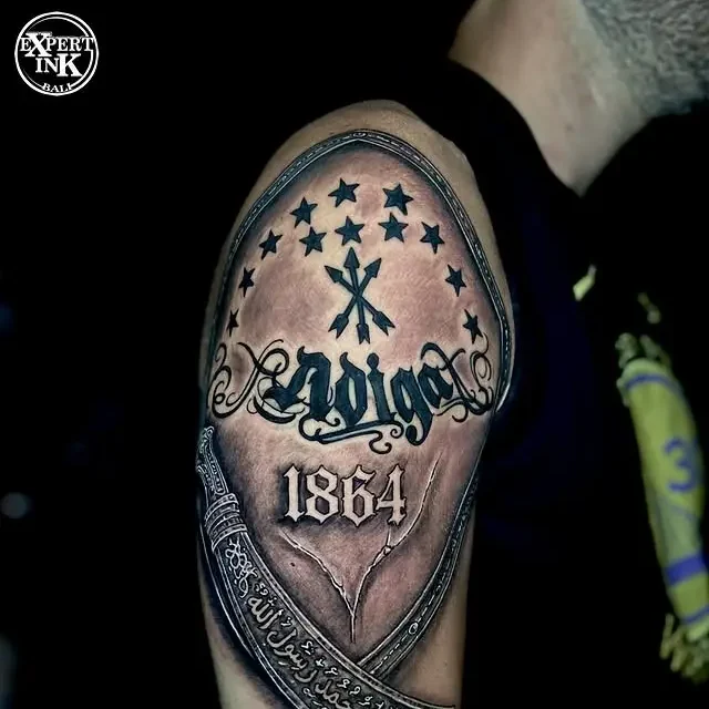 Custom tattoos in Bali Kuta featuring bold blackwork lettering and script design on the arm