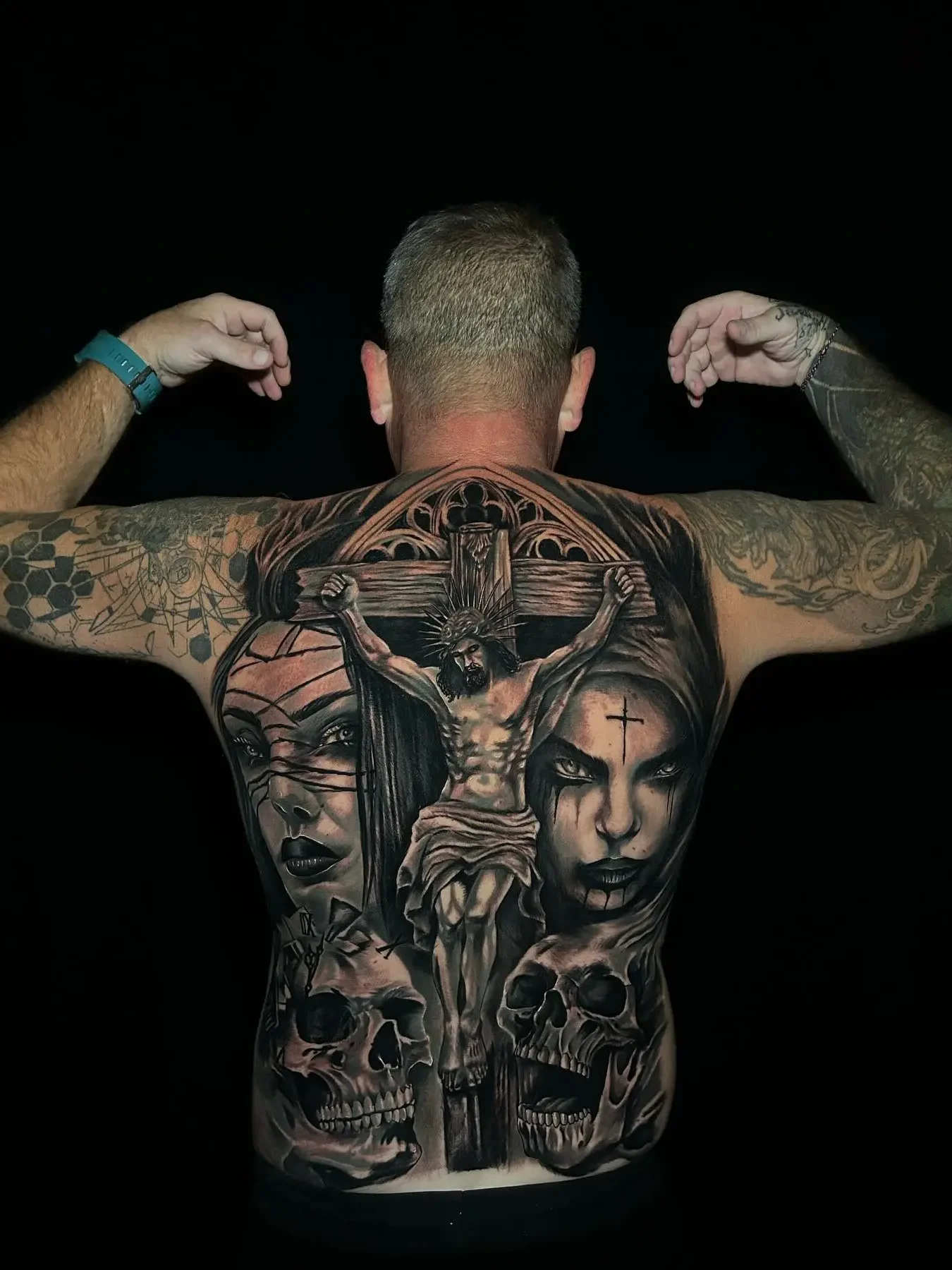 Full back tattoo in Bali featuring black and grey realism portrait design