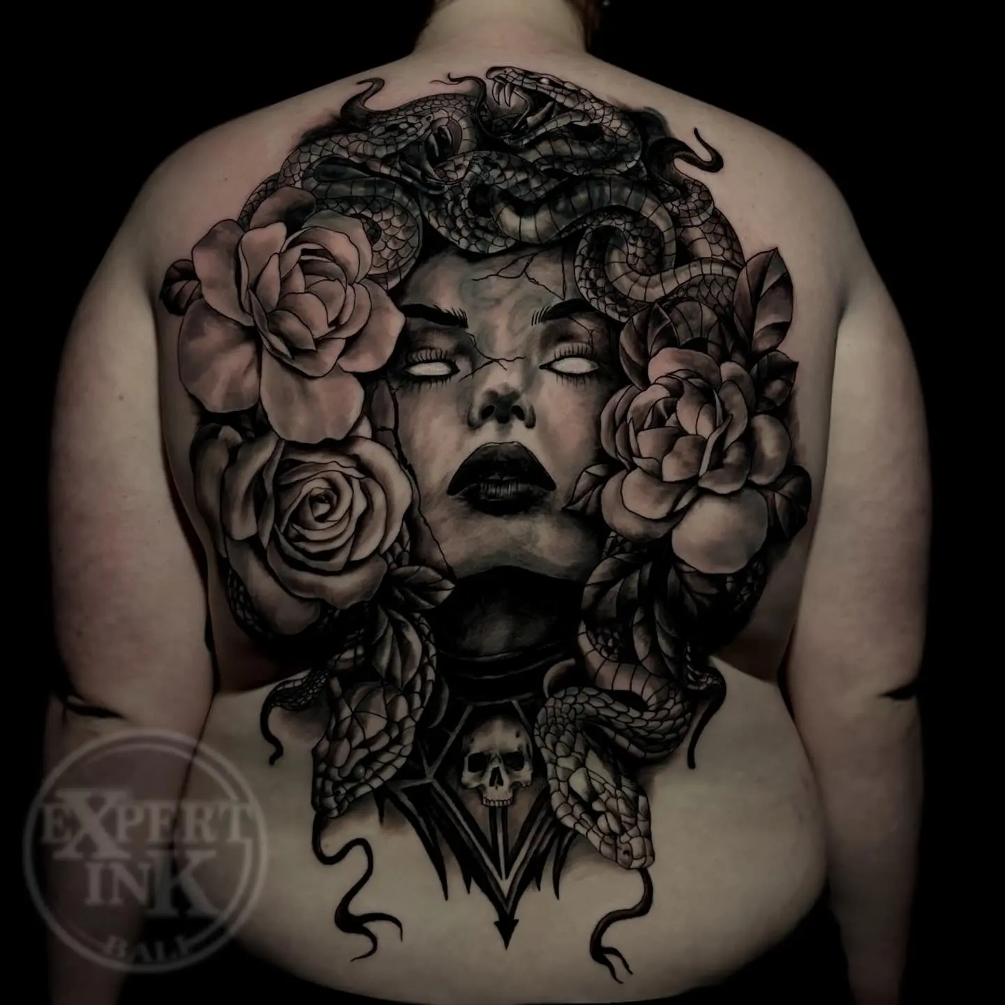 Bold back tattoo Kuta designs blending lion and floral realism elements
