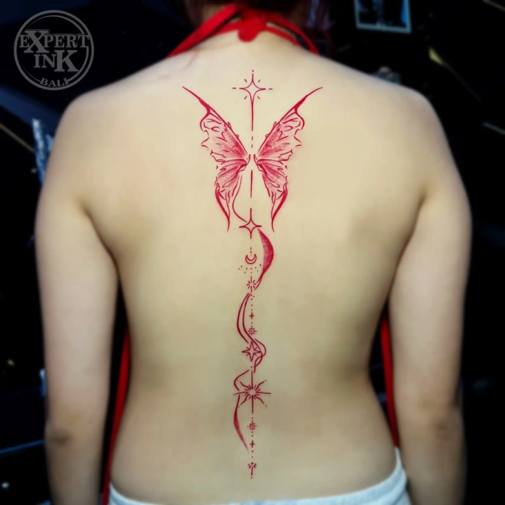 fine line back tattoo in Bali featuring artline and script