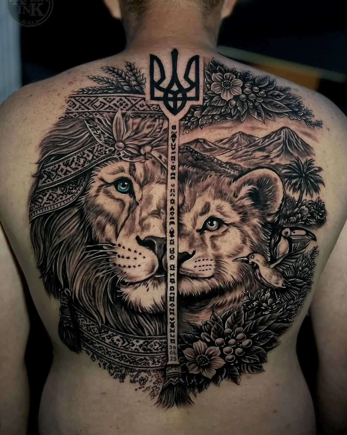 Bold back tattoo Kuta designs blending lion and floral realism elements