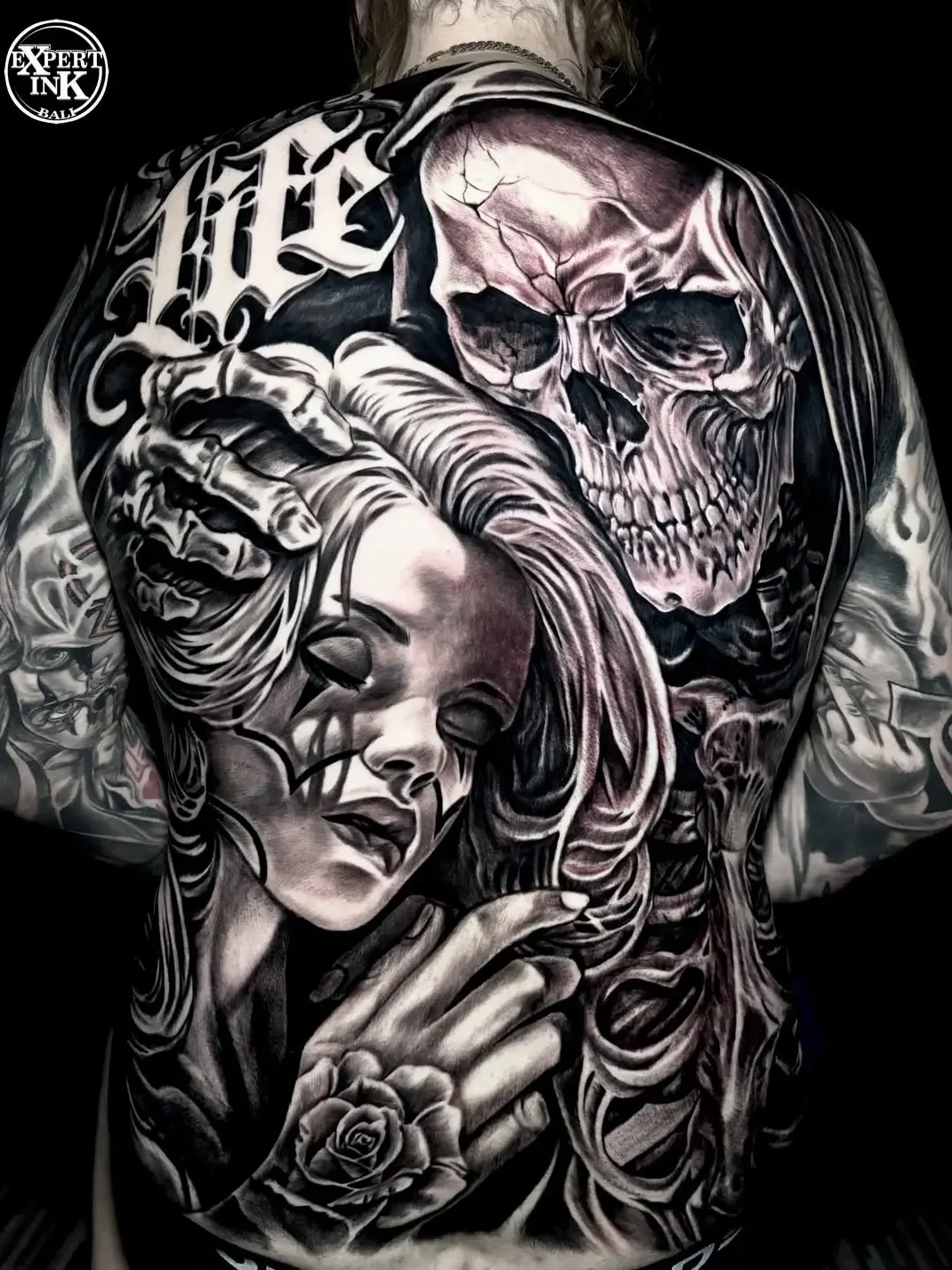 Full back tattoo in Bali featuring black and grey realism portrait design