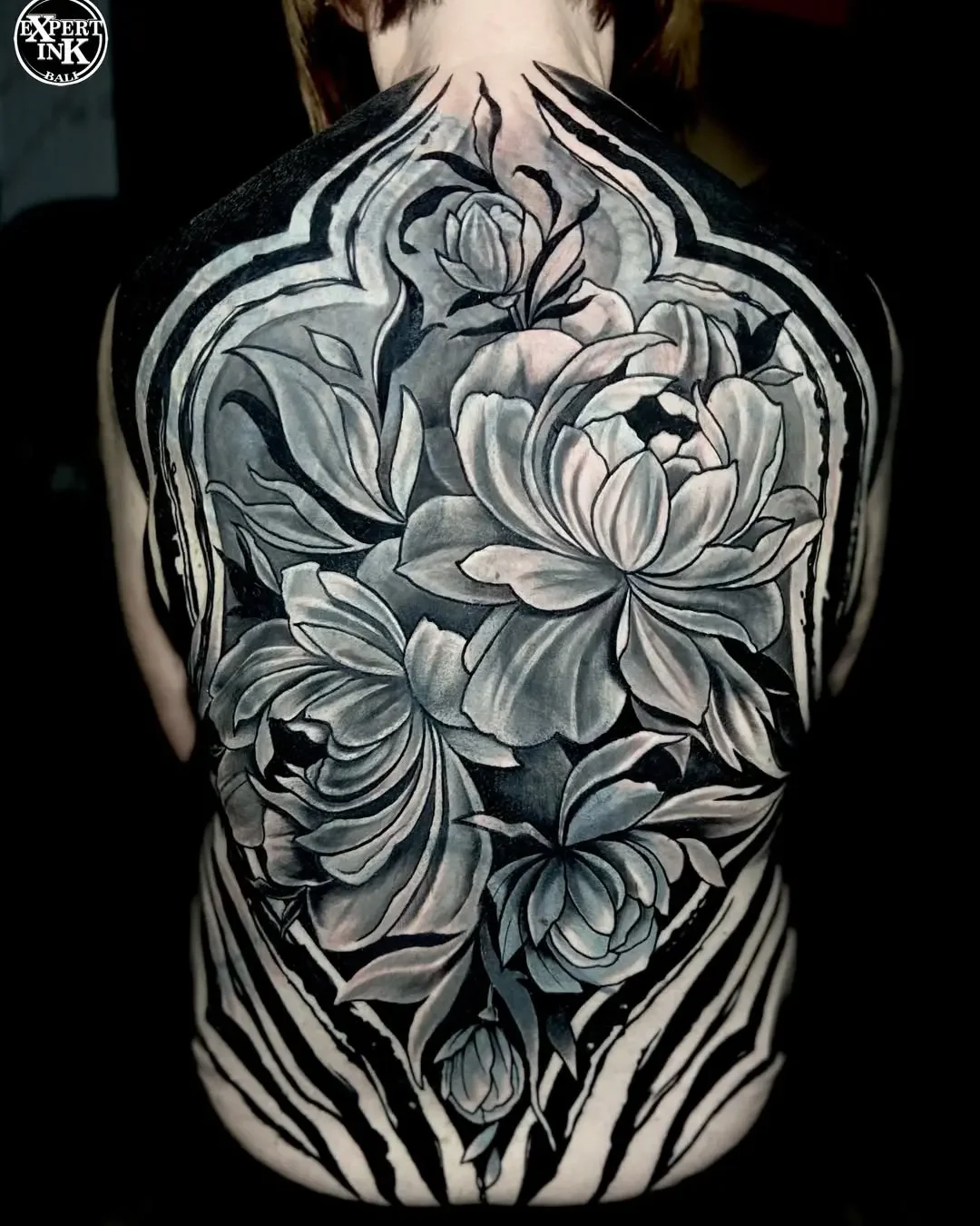Full back tattoo in Bali featuring black and grey realism portrait design